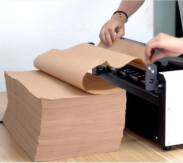 Loading the flat kraft paper stack into the paper bubble machine