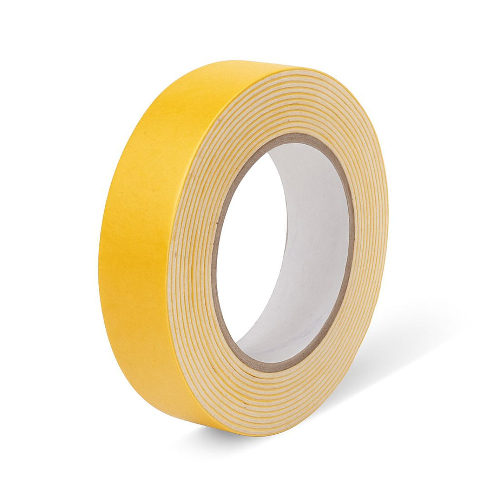 Double sided foam mounting tape 24 mm roll, side angle of the yellow liner and paper core