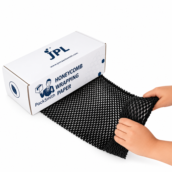 Black honeycomb wrapping paper drawn out of a PackSmith dispenser box, hands stretching the paper mesh